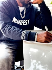 a man sitting at a desk with a pen and paper